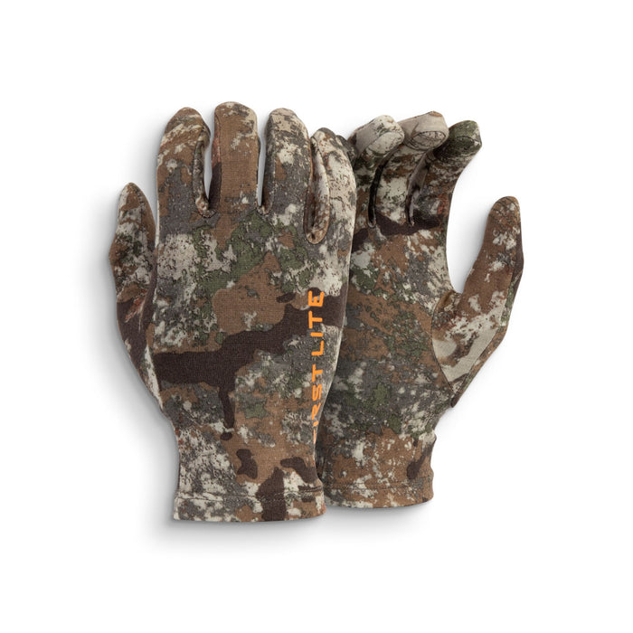 A pair of camouflage gloves with orange "FIRSTLITE" text visible on the left wrist.