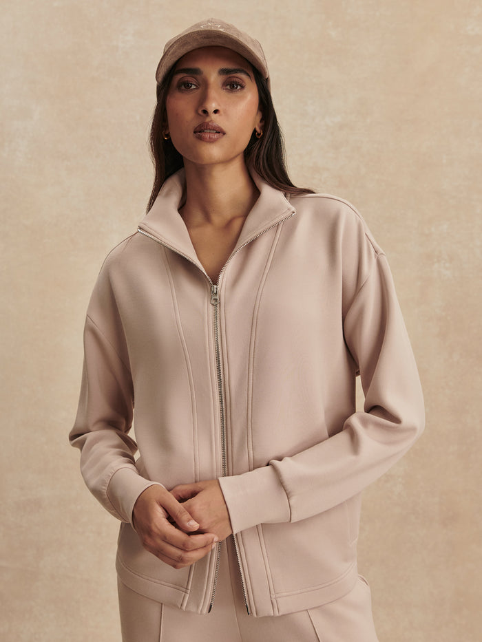 Mushroom|Model wearing Arlene Zip Through Sweat in Mushroom, a 2-way zip-through DoubleSoft® piece with grown-on neck, standard fit and vertical welt pockets.