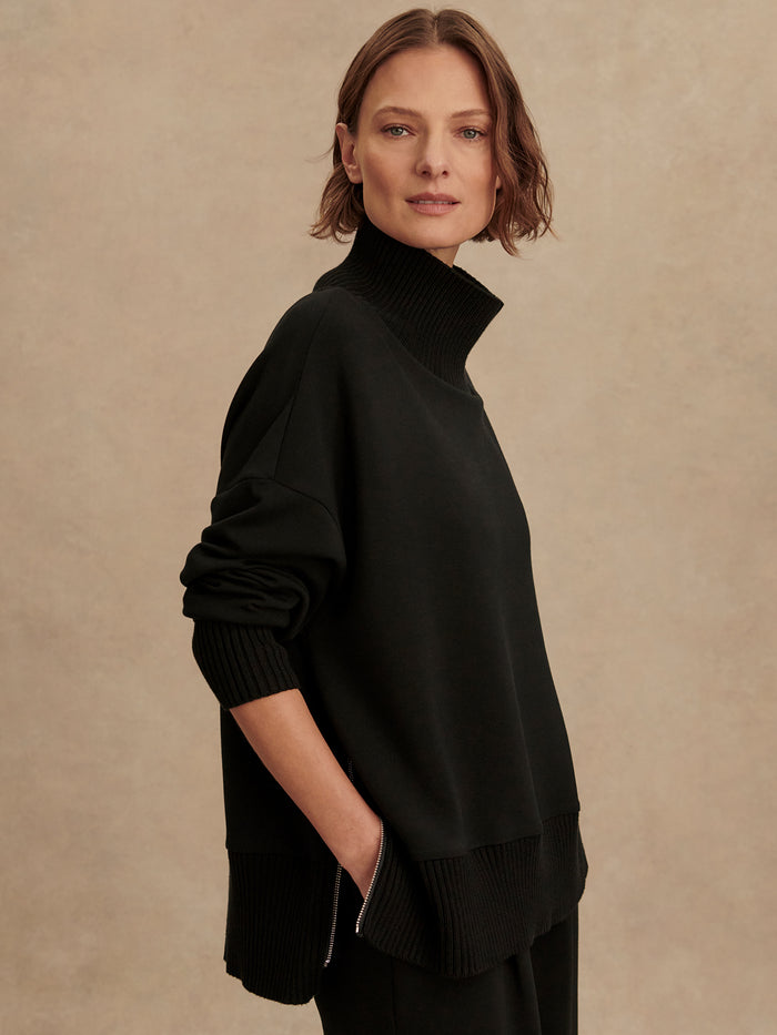 Black|Model wearing Barker High Neck Sweat in black, showcasing a high-neck sweatshirt.