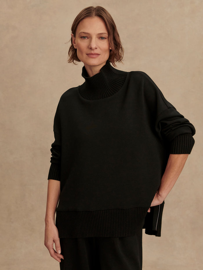 Black|Front view of Varley Barker High Neck Sweat in Black, a high-neck pullover sweatshirt with a streamlined silhouette.