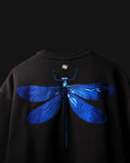 Black T-Shirt with a blue dragonfly design on a dark background