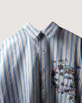 Striped shirt with a colorful butterfly design on a light gray background
