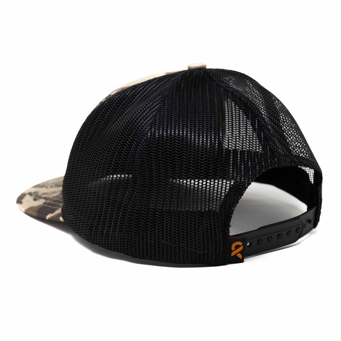 Camo trucker hat with black mesh back, snap closure, and orange logo tag.