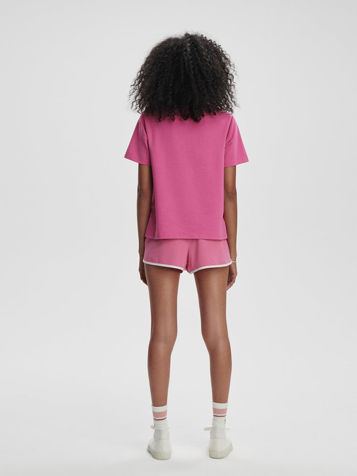 Ibis Rose|Coventry Branded Tee in Ibis Rose, front view of a soft pink tee with short sleeves and classic fit.