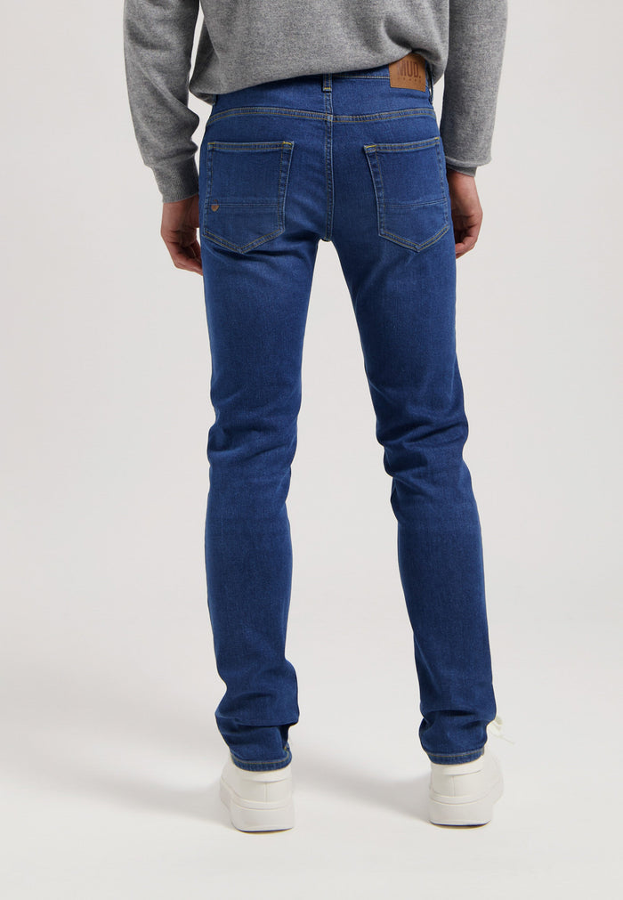 Sustainable MUD Jeans denim jacket and jeans in medium blue wash, showcasing ethical fashion in classic fit.