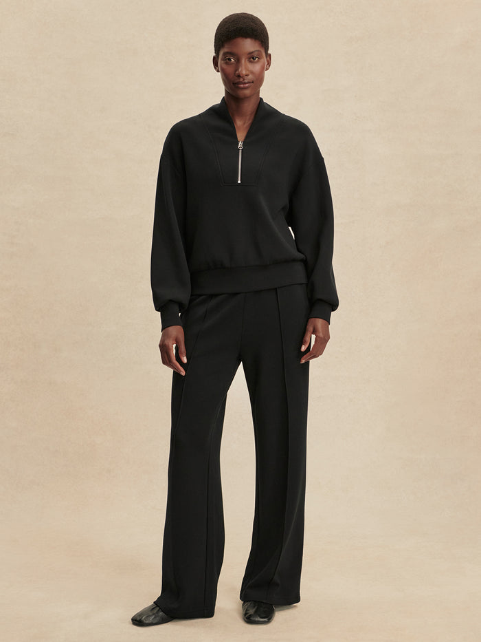 Black|Model wearing the Davidson Sweat in Black, a Varley crew-neck sweatshirt with long sleeves and relaxed fit.
