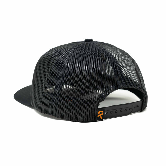 Black trucker cap with a mesh back, snapback closure, and a small orange logo on the strap.