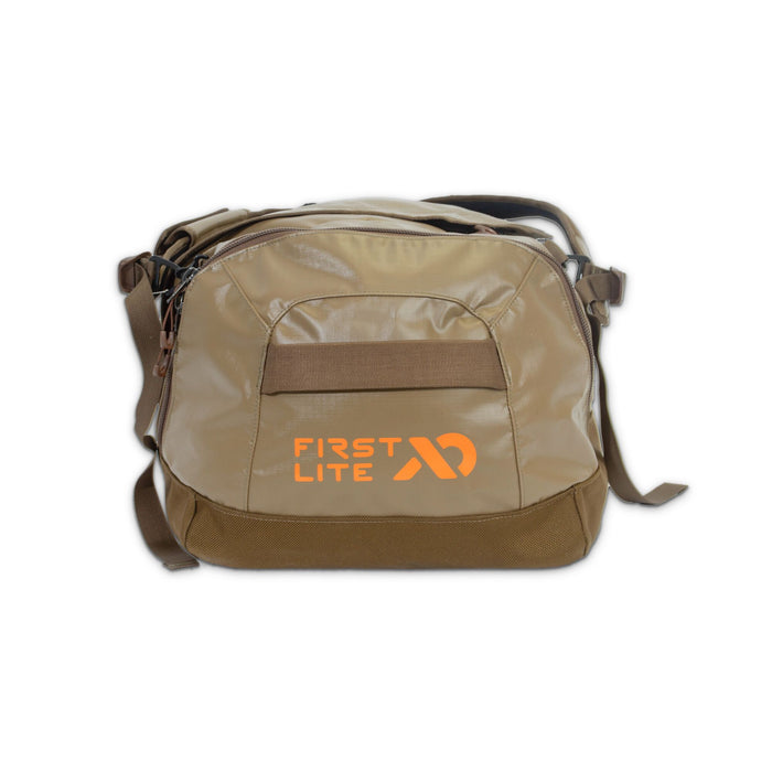 Two-tone tan and brown First Lite duffel bag with an orange logo and a front grab strap.