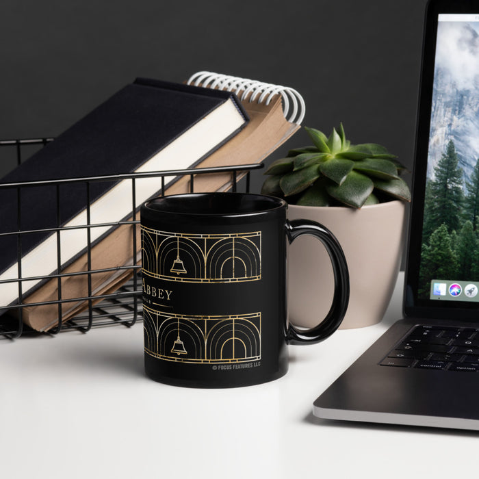 Angle view of the Downton Abbey black mug showing the print placement against the glossy finish