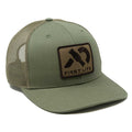 Olive green trucker hat featuring a dark brown rectangular patch on the front with a black stylized duck call graphic and "FIRST LITE" text.