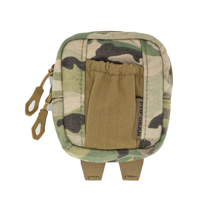 Multicam camouflage utility pouch with a tan elastic front pocket, two brown zipper pulls, a visible FHF GEAR label, and two bottom attachment straps.