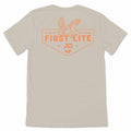 Beige t-shirt with an orange back graphic featuring an eagle, "FIRST LITE" text, and a hexagonal outline.