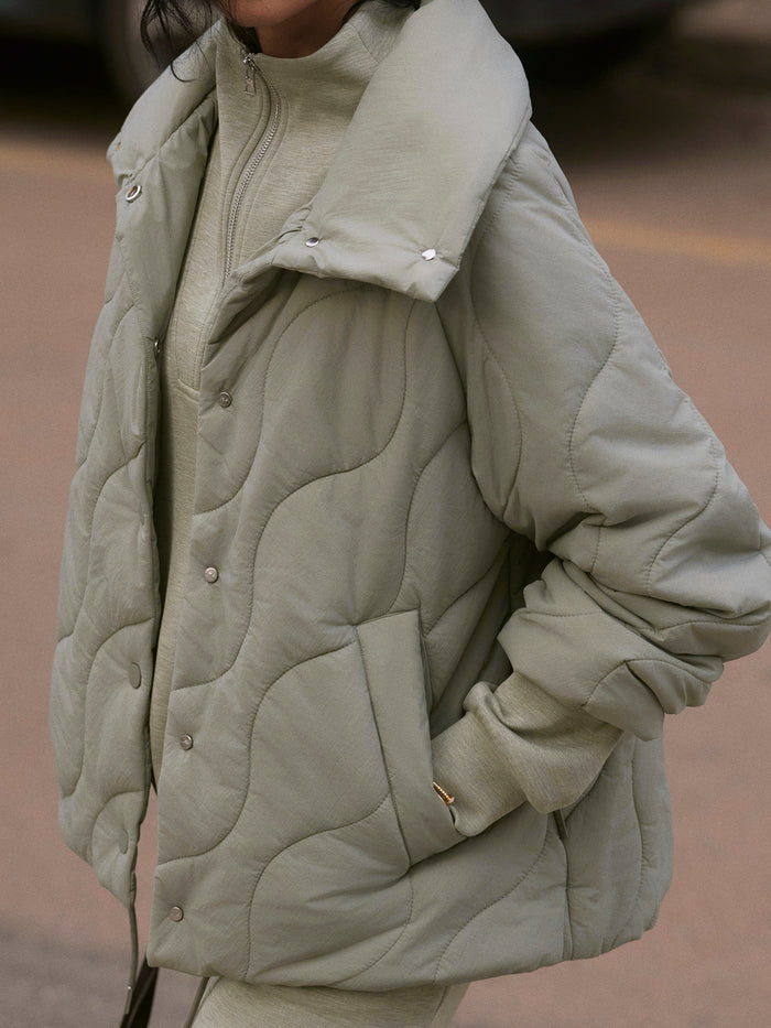 Shadow|Front view of the Fabia Quilted Jacket in Shadow, a padded quilted jacket with a full-zip front and standing collar.