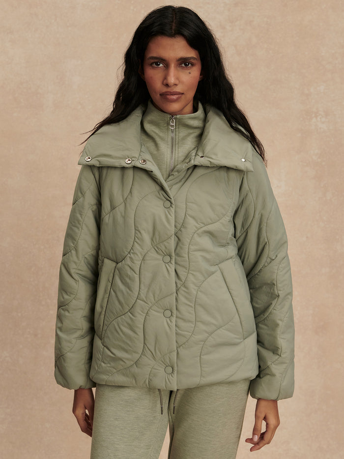 Shadow|Front-facing view of the Fabia Quilted Jacket Shadow, a quilted jacket with a high collar and front zip closure.