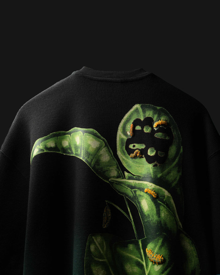 Black Fade Flora with green caterpillar design on a dark background