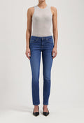 Slim-fit blue women’s jeans paired with a gray sleeveless top and black pointed-toe heels.