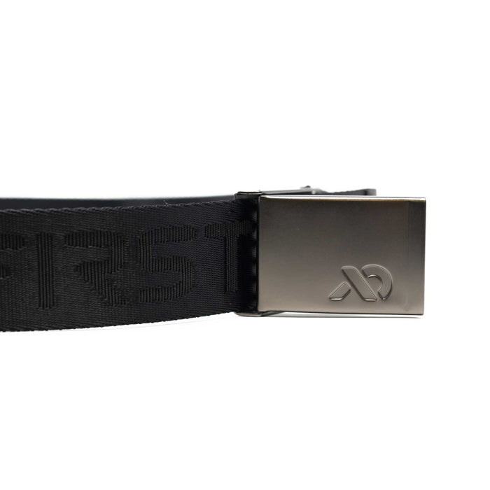 Close up of silver buckle with First Lite logo and a black belt.