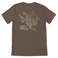 Brown T-Shirt with a beige map of North and Central America and a duck, and text "FLYWAYS OF NORTH AMERICA" and "FIRST LITE" below.