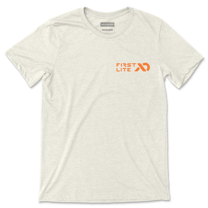 Light heathered t-shirt with orange First Lite logo on the left chest and Meateater Medium neck tag.