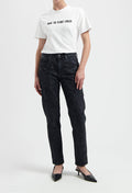 Casual white t-shirt with "Make the Planet Cooler" slogan, paired with black acid-washed jeans and black pointed heels.