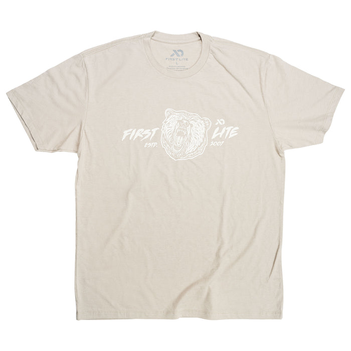 Beige t-shirt with a white graphic of a roaring bear head and "FIRST LITE ESTP. 2007" text.