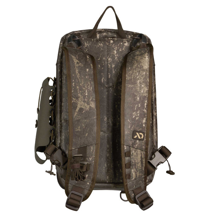 Rear view of a dark camouflage backpack with padded shoulder straps, top carry handle, side lacing system, and lower buckles.