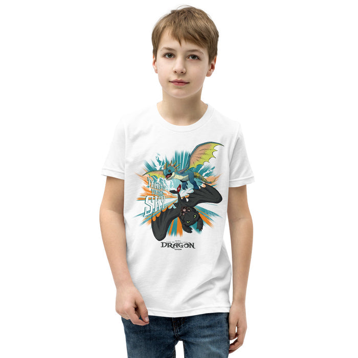 White youth t-shirt featuring Toothless, Hiccup, and Stormfly graphic print on the front chest