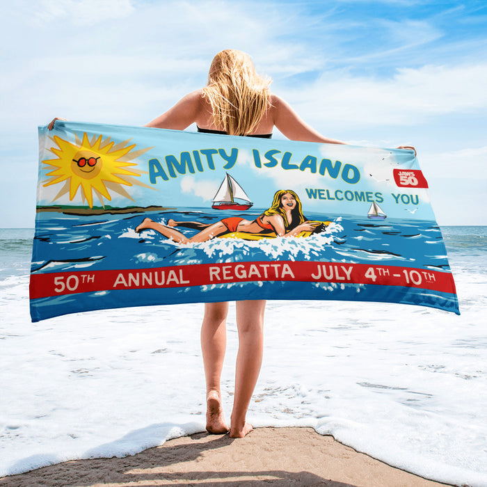 Folded Jaws beach towel highlighting the durable cotton and polyester blend and anniversary branding