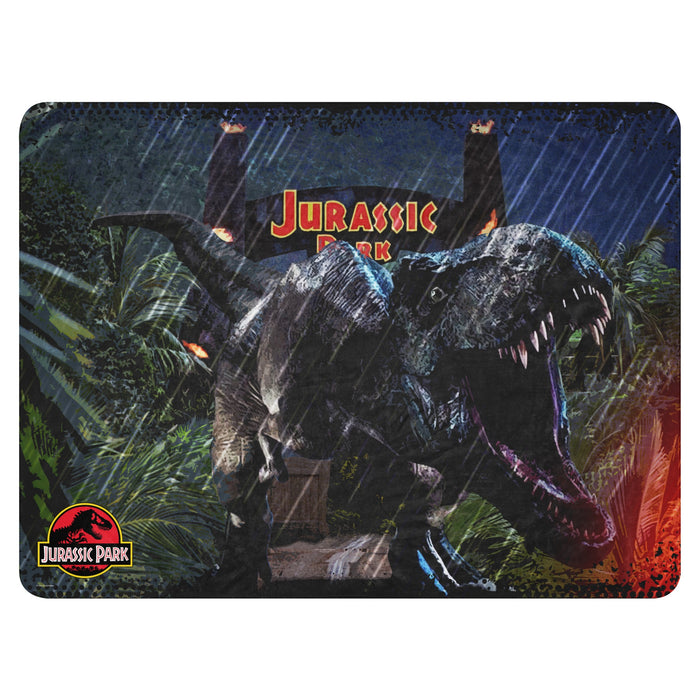 Folded Jurassic Park jungle sherpa blanket showing the lush green foliage pattern and plush texture