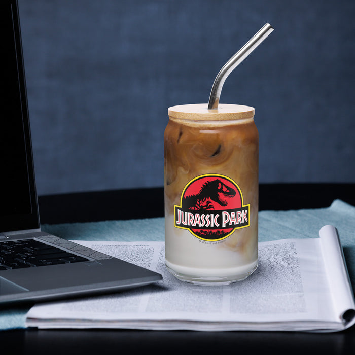 Jurassic Park can shaped glass shown alongside its included lid and straw against a neutral background
