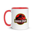 White ceramic coffee mug featuring the red Jurassic Park skeleton logo on the front