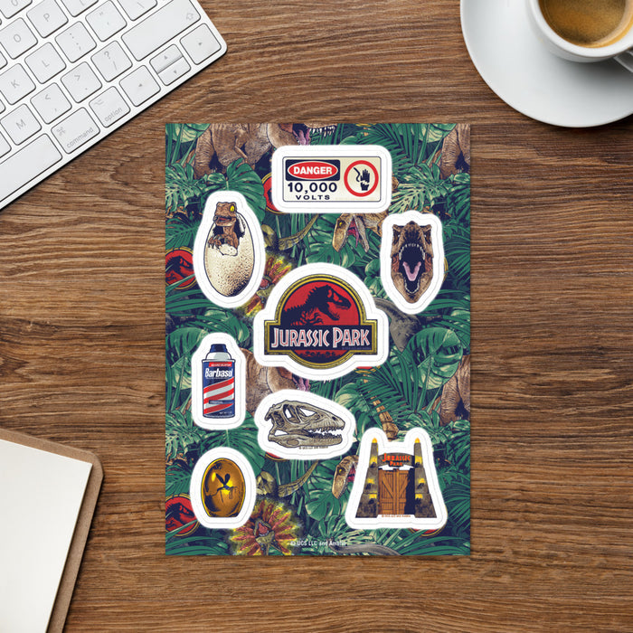 Close-up of individual glossy Jurassic Park stickers featuring classic movie branding and dinosaur graphics