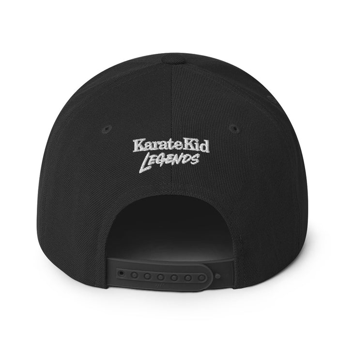 Side profile of the black Karate Kid snapback hat showing the structured wool blend crown and stitching details