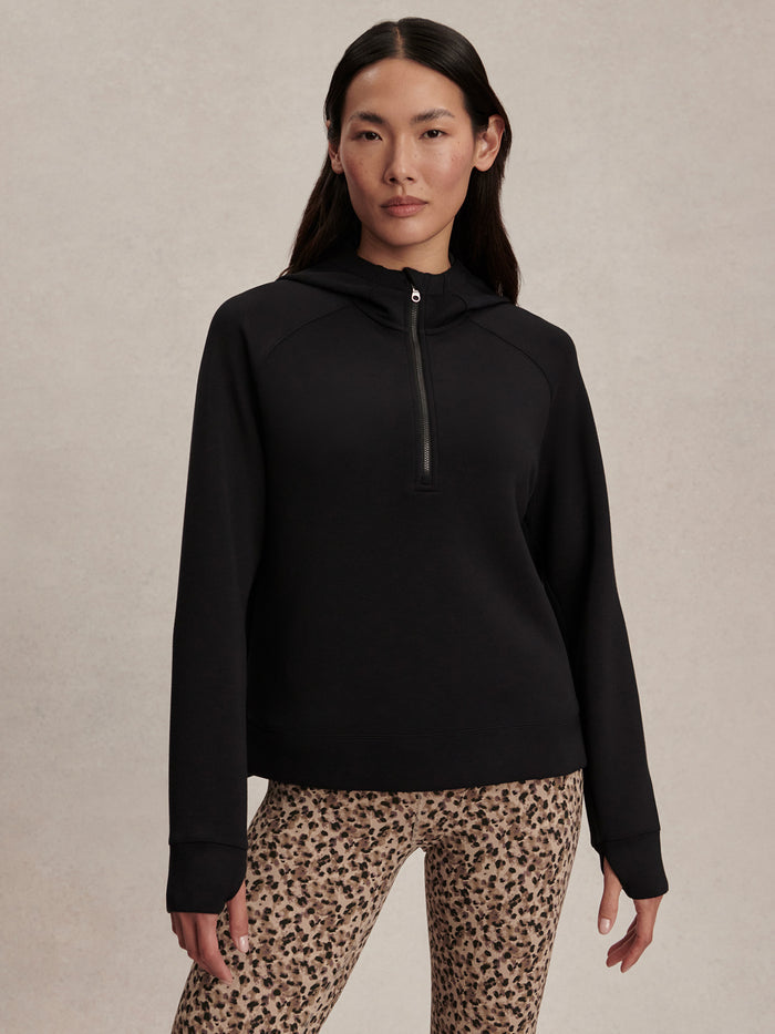 Black|Varley KARO Half Zip Midlayer in Black, front view with a high neck and exposed black half-zip, long sleeves, midweight knit fabric.