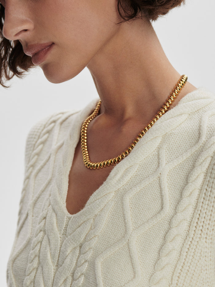 Snow White|Kay Cable Knit Vest Snow White, a cable-knit sleeveless vest in Snow White, ideal for layering.