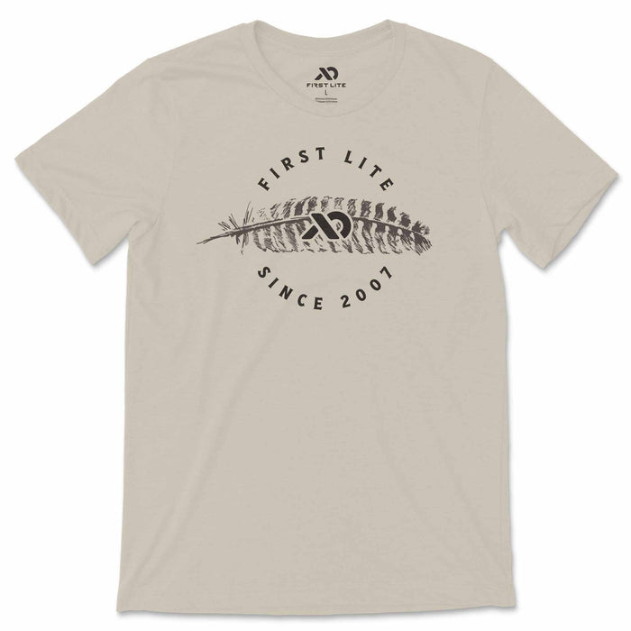 Sand t-shirt featuring a dark gray 'FIRST LITE' feather graphic and 'SINCE 2007' text.