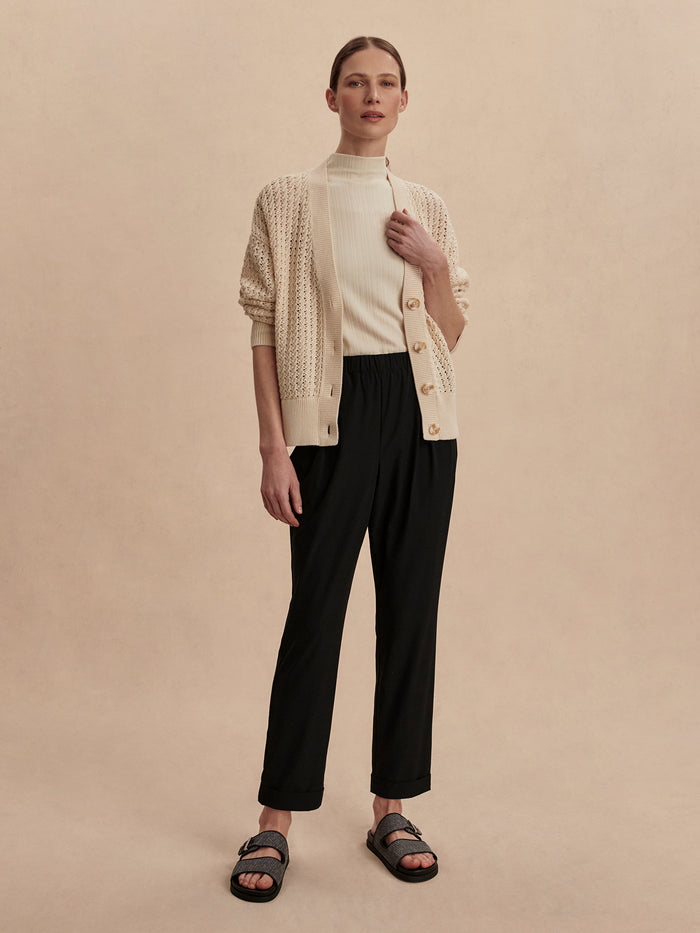 Black|Front view of the Alana Slim Tapered Cuff Pant 27 Black, a black slim pant with a tapered leg and cuffed ankle.
