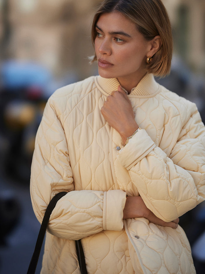 Reed Yellow|Front-facing Luca Quilted Jacket in Reed Yellow, a quilted puffer-style jacket.