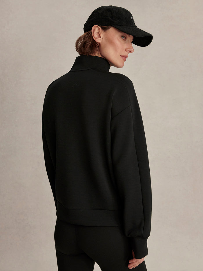 Black|Front view of the Varley Marissa Half Zip Midlayer in Black, a lightweight midlayer with a centered half-zip.