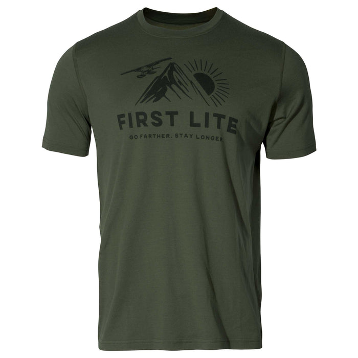 Olive green t-shirt featuring a black graphic with "FIRST LITE" text, mountains, a sun, a small plane, and "GO FARTHER. STAY LONGER" slogan.