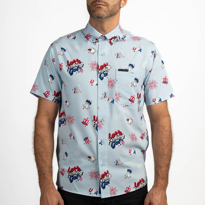 Man wearing a light blue button-up shirt with colorful graphic designs on a white background