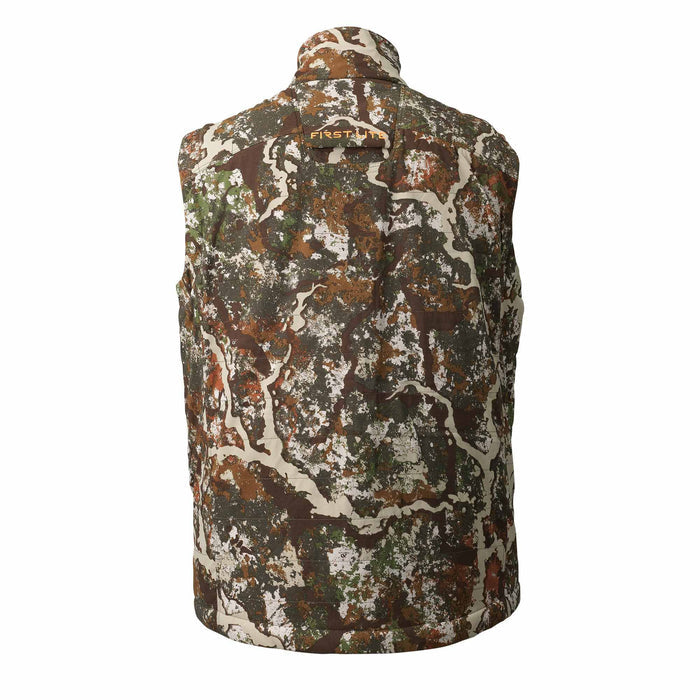 Back of a First Lite quilted vest in brown, green, and white tree-like camouflage, with the brand name in orange on the upper back.