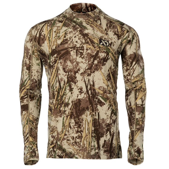 Long-sleeve mock neck shirt in a beige, brown, and green marsh camouflage pattern, with a black chest logo and thumbholes.