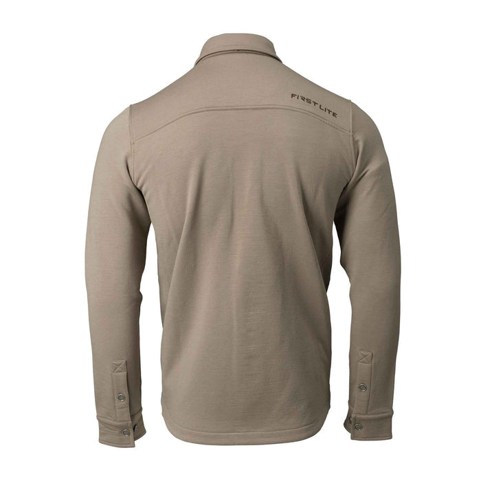 Back view of a tan long-sleeve collared shirt with "FIRST LITE" logo on the upper back and buttoned cuffs.