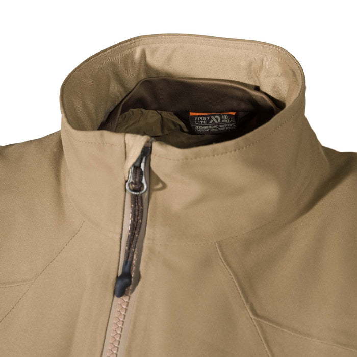 Tan men's First Lite jacket with a high collar, brown front zipper, and internal brand tag.