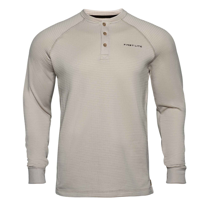 Light tan First Lite long-sleeve Henley shirt with a horizontal ribbed texture, raglan sleeves, three brown buttons, and ribbed cuffs.