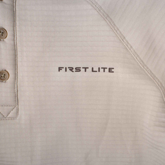 Light brown long-sleeve shirt with a 3-button placket, visible flatlock seams, and "FIRST LITE" logo.