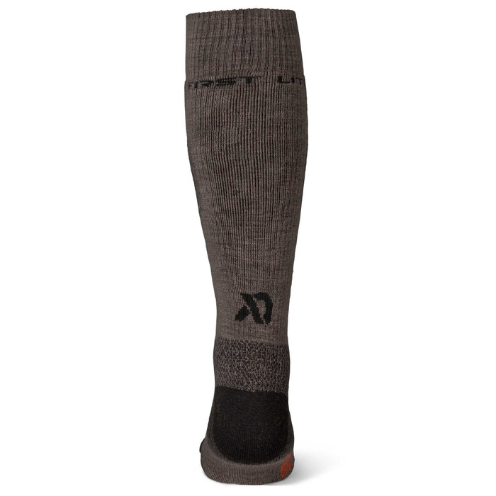 Dark brown ribbed calf sock with black heel and toe, "FIRSTLITE" text on the cuff, an abstract logo on the calf, and a small orange mark on the toe.