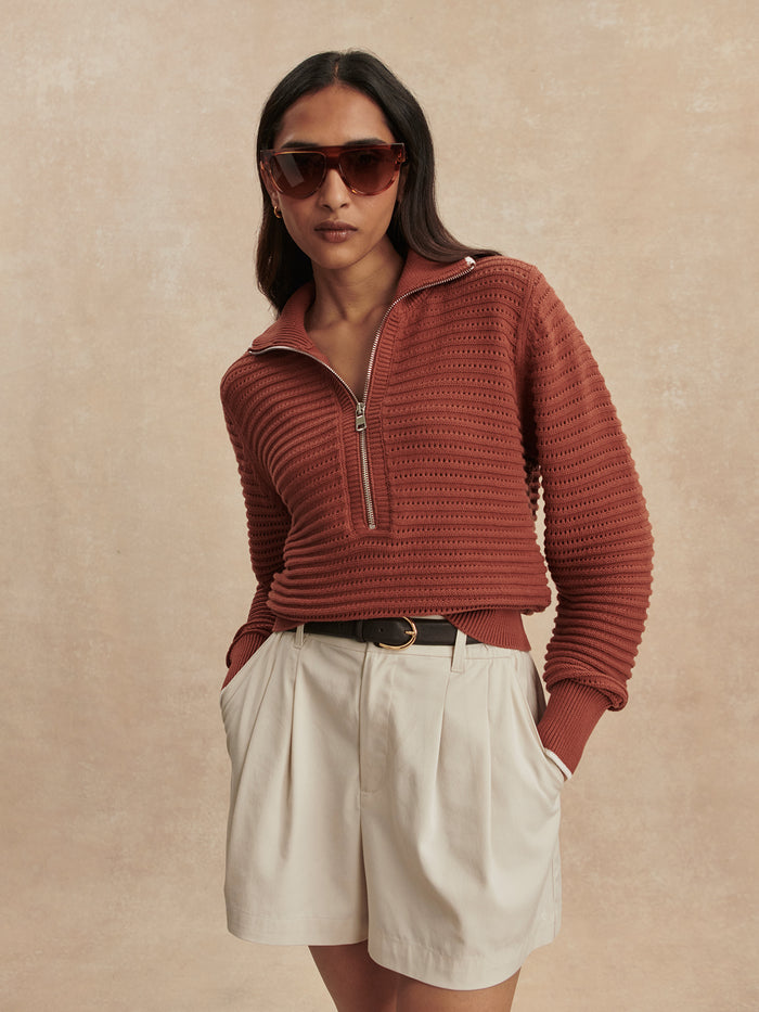 Maple|Model standing facing forward, wearing the Morwenna Half Zip Knit in maple brown, featuring a relaxed fit, high neck, and ribbed cuffs and hem.