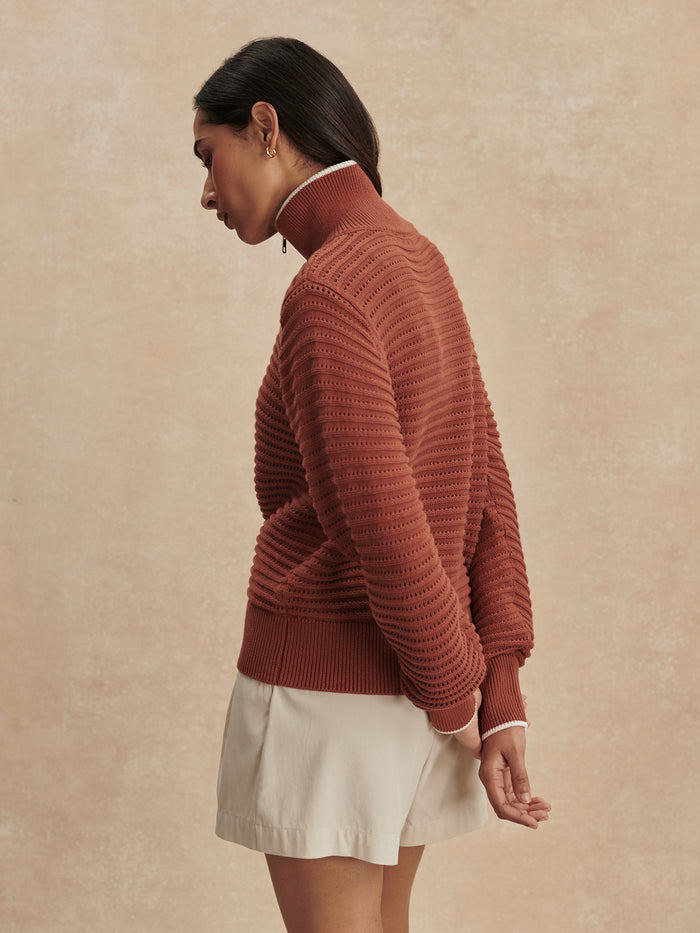 Maple|Model wearing Morwenna Half Zip Knit in Maple, featuring a high neck with half-zip, long sleeves and ribbed trims.